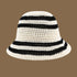 A white crochet bucket hat with black stripes, featuring a lightweight, breathable weave perfect for beach days and vacations.