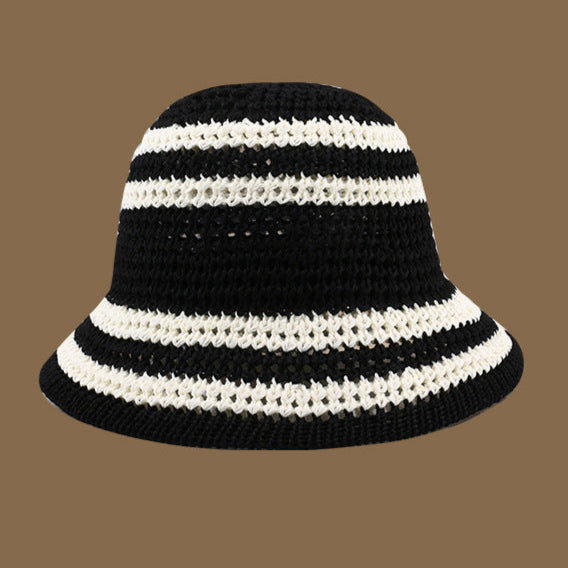 A black crochet bucket hat with white stripes, featuring a chic, monochrome design that pairs effortlessly with any outfit.