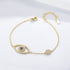 Gold evil eye bracelet with blue and clear CZ stones on a fine chain.