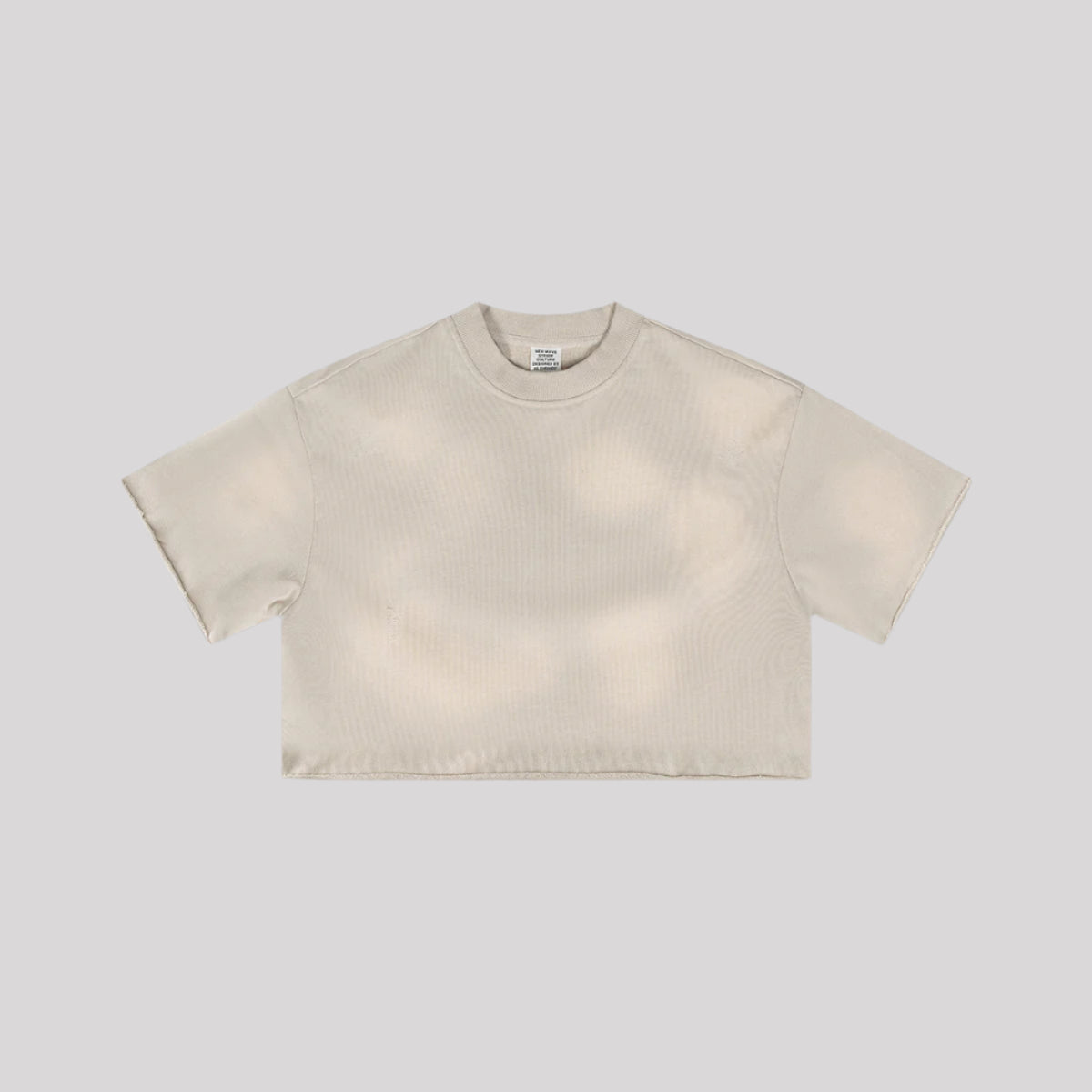 Beige cropped t-shirt with crew neck and short sleeves displayed flat against light gray background
