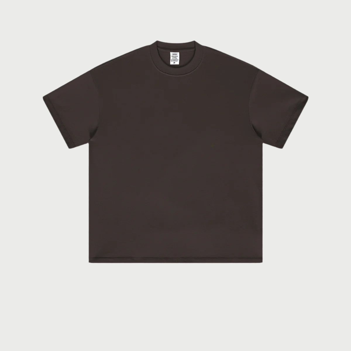 Dark brown oversized t-shirt displayed flat against light gray background with branded tag visible
