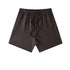 A dark brown pair of shorts with elastic waistband and matching drawstrings displayed on a white background