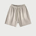 Light beige drawstring shorts with elastic waistband displayed flat against light gray background