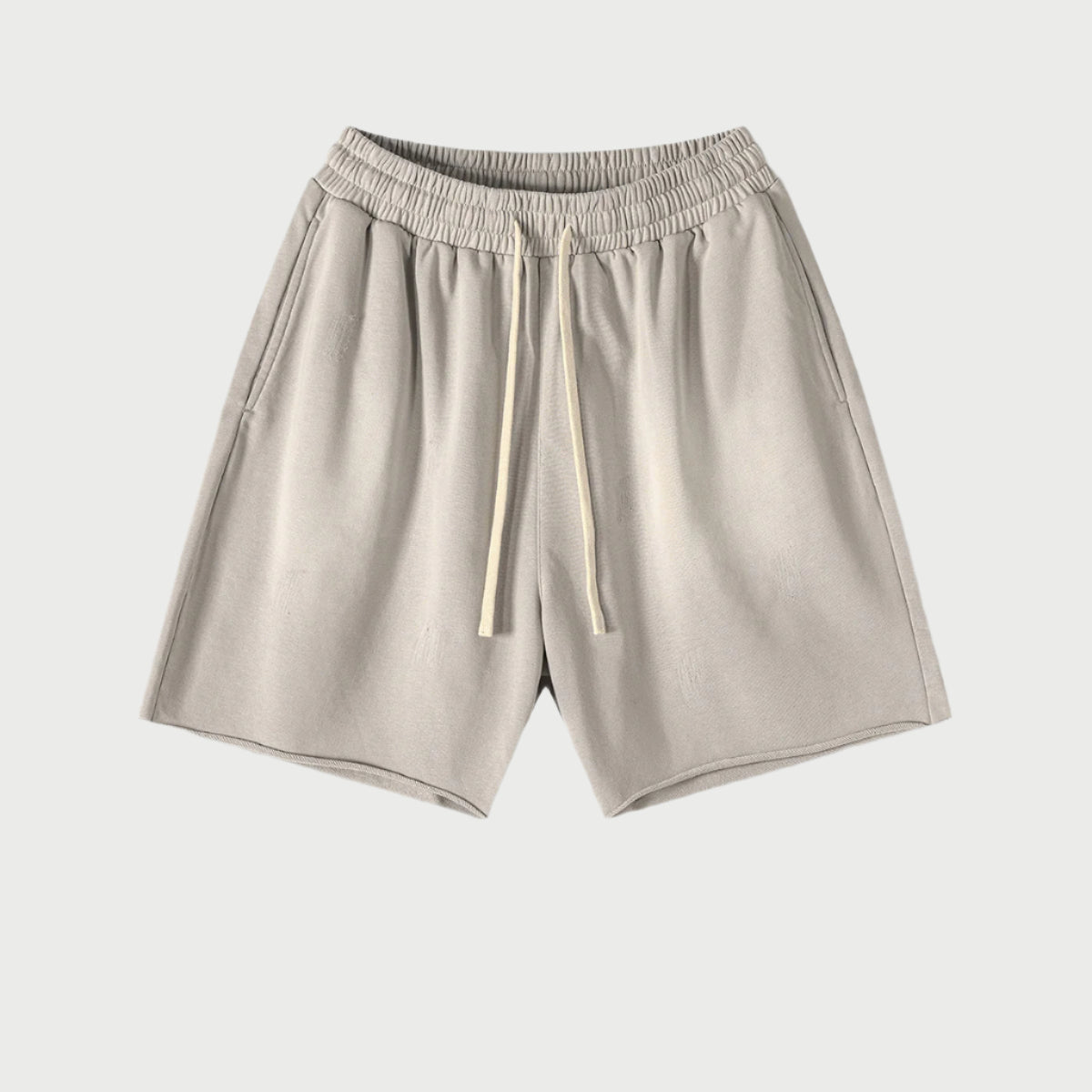 Light beige drawstring shorts with elastic waistband displayed flat against light gray background