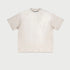 Cream colored oversized t-shirt with raglan sleeves displayed flat against light gray background