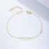 Gold bar bracelet with CZ accents laid flat on a white background.