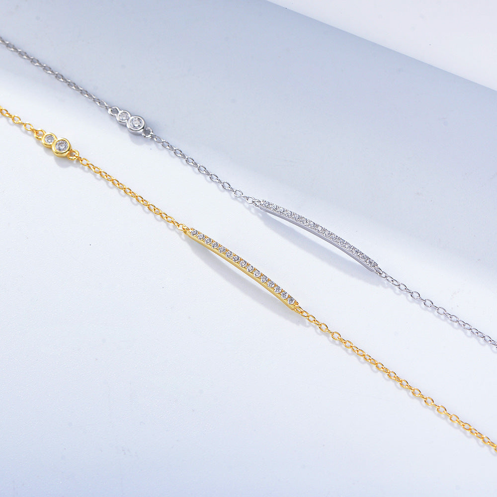 Side-by-side comparison of gold and silver bar bracelets with CZ accents.