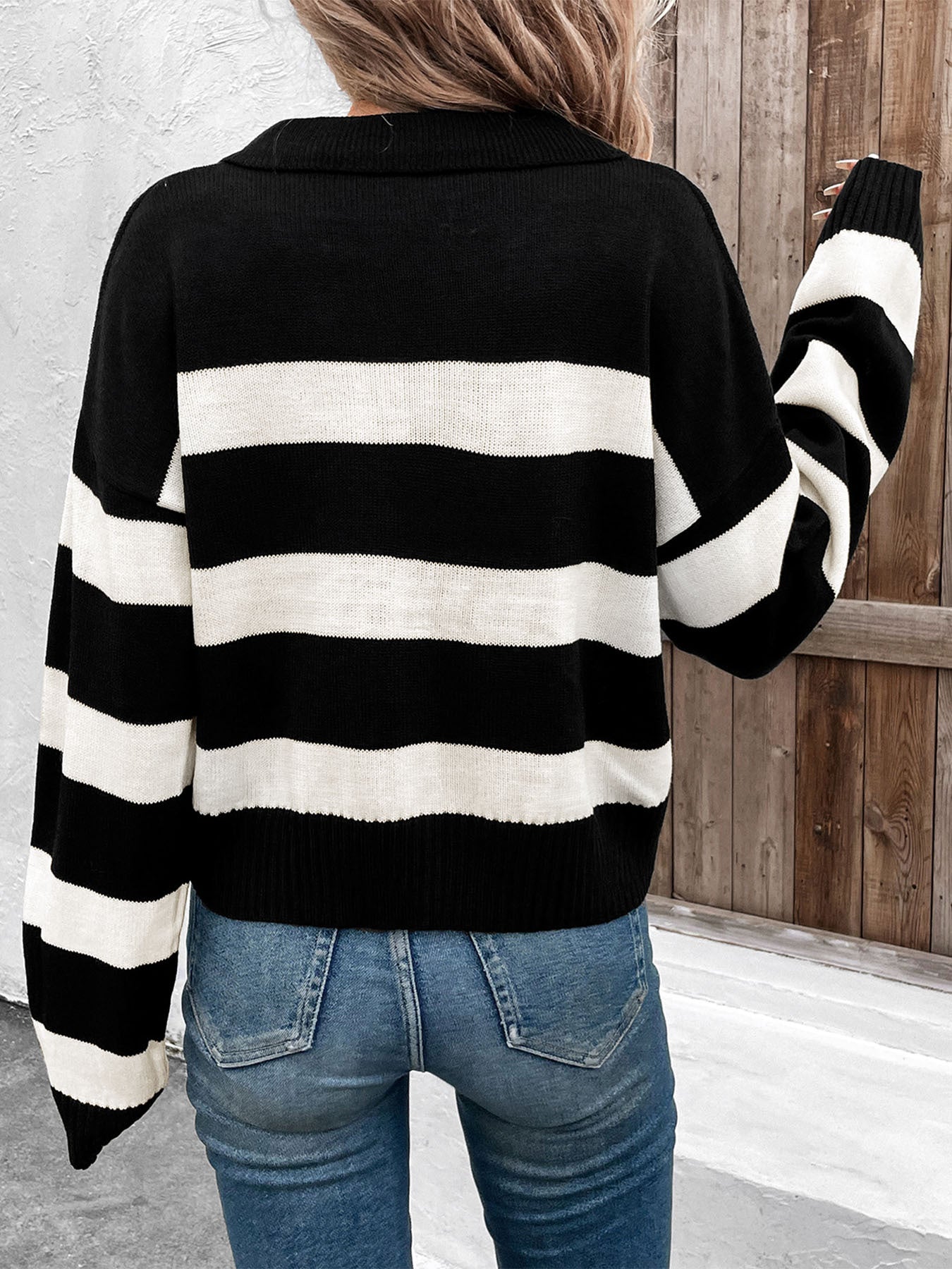 Striped black and white collared sweater paired with jeans and gold necklaces