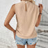 Beige mock neck sleeveless top paired with distressed denim shorts