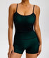 A woman is wearing a forest green seamless spaghetti strap bodysuit with built-in shorts against white background, highlighting contoured waistline