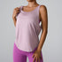 A woman is wearing a light lavender sleeveless tank top with a scoop neckline and matching bright purple leggings, posing against a neutral backdrop