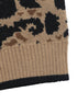 Close-up of cardigan hem showing ribbed tan border with black trim and leopard pattern above