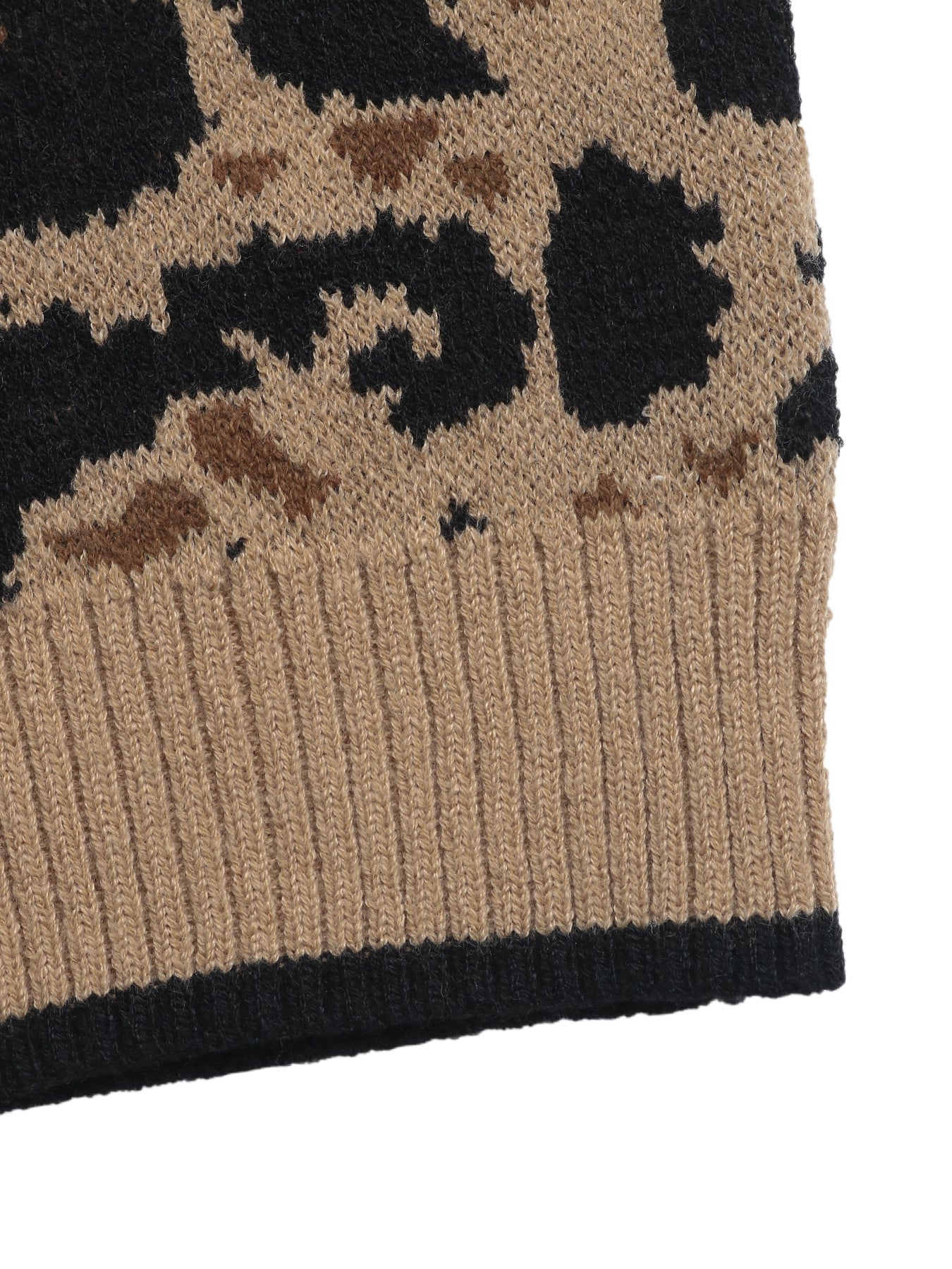 Close-up of cardigan hem showing ribbed tan border with black trim and leopard pattern above