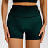 Forest green high-waisted athletic shorts with seamless design and black contrast details