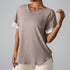 Taupe athletic top with white sleeve accents showing comfortable fit and premium fabric quality