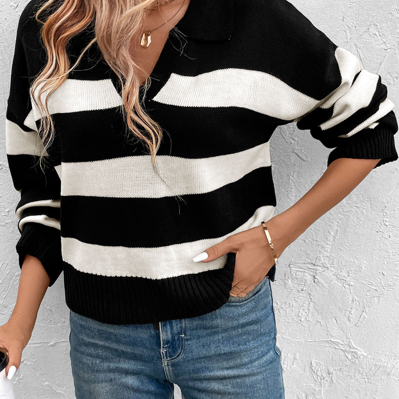Striped black and white collared sweater paired with jeans and gold necklaces