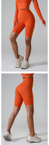 Orange compression bike shorts with high waist and seamless design, styled with matching long sleeve top and chunky sneakers
