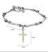 A close-up of a silver bone-textured bracelet with a detailed gold cross pendant against a white background.