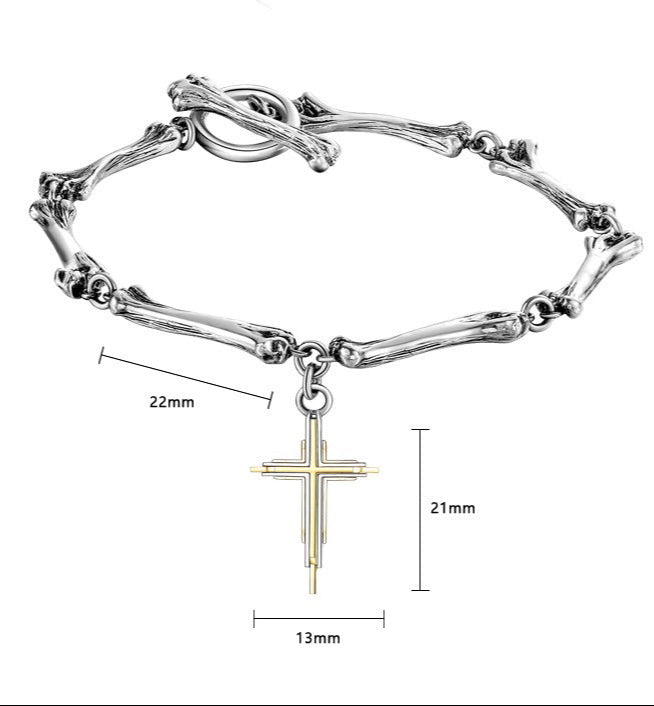 A close-up of a silver bone-textured bracelet with a detailed gold cross pendant against a white background.