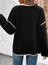 Women's black cardigan with white contrast stitching detail and front pockets