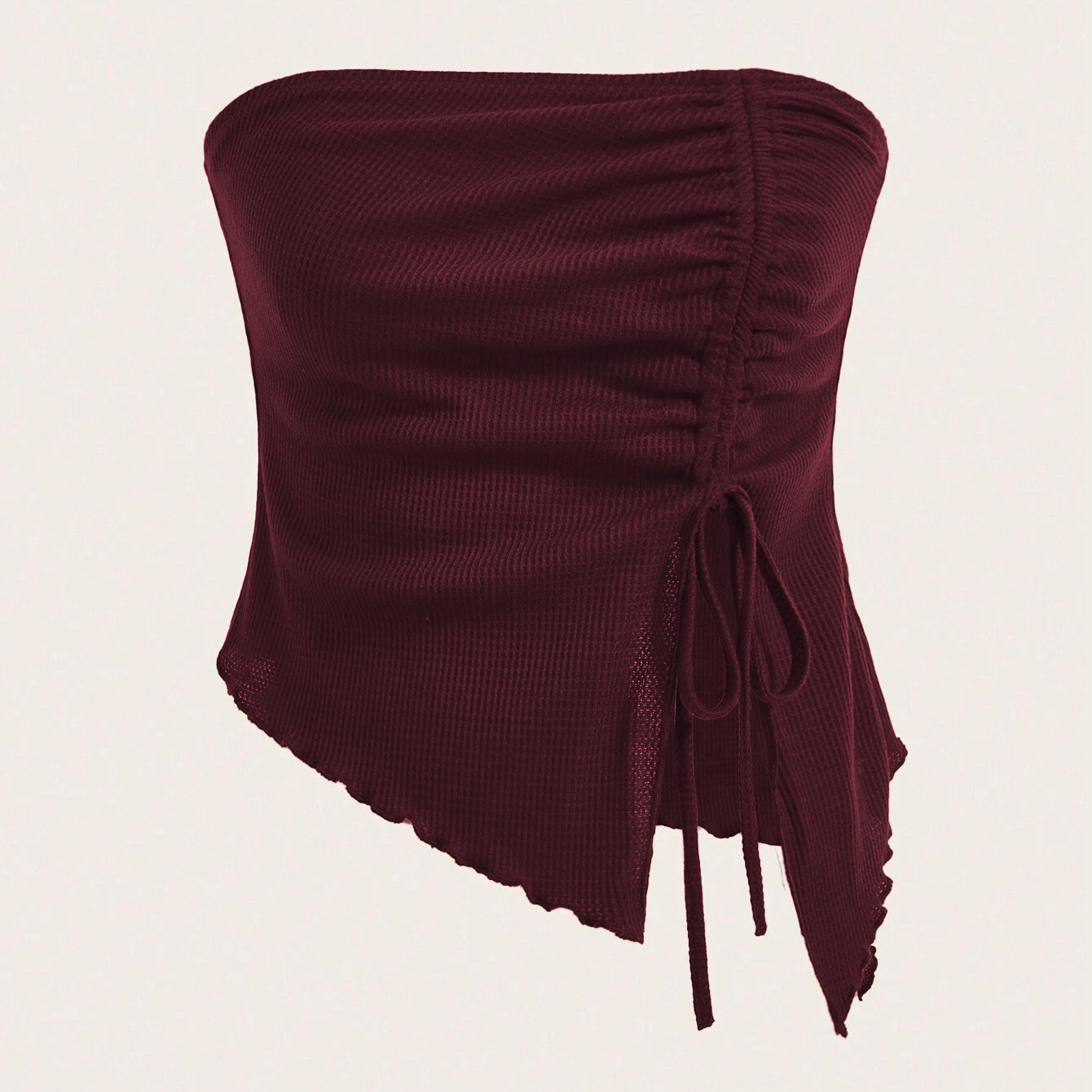 A close-up detail shot of burgundy ribbed fabric with lettuce edge trim and mesh panels showing garment construction
