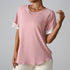 Detailed view of pink athletic top showing raglan sleeve construction and breathable fabric texture