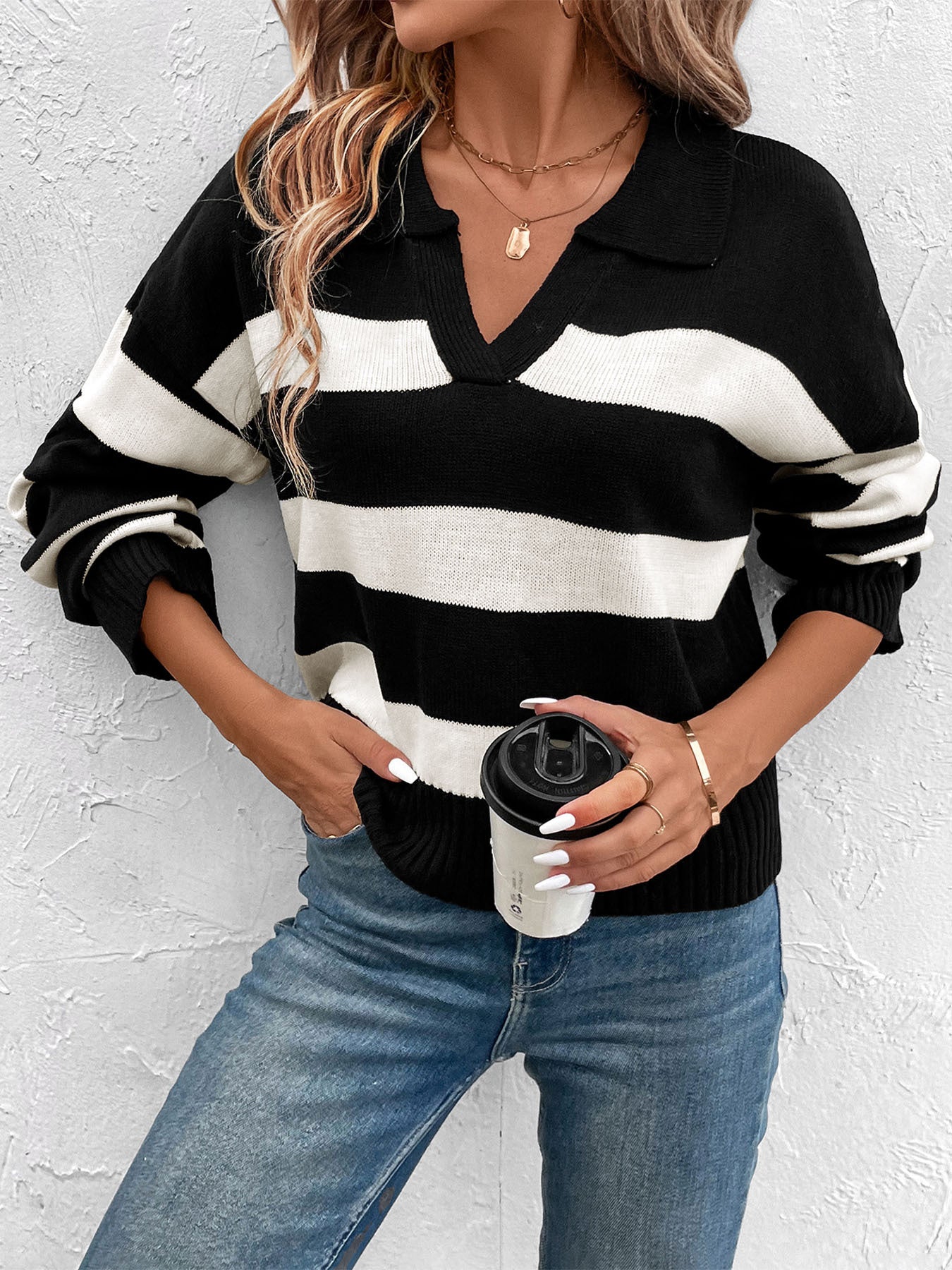 Striped black and white collared sweater paired with jeans and gold necklaces
