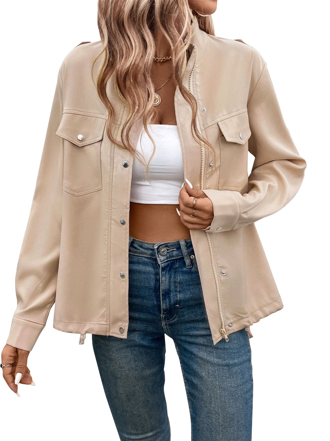 Women's beige utility jacket with front pockets and button details, styled casually with crop top