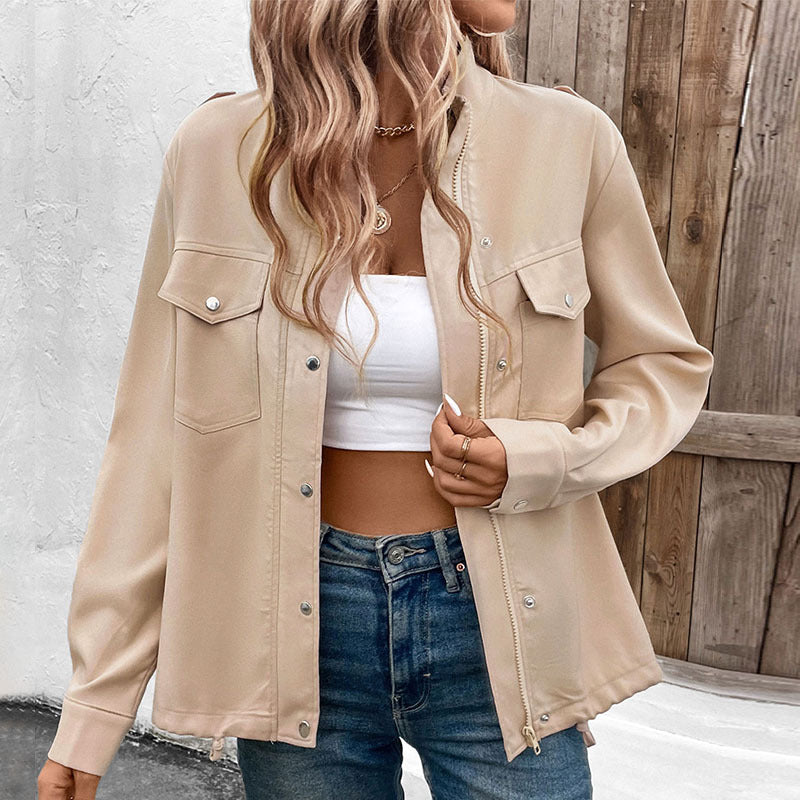 Women's beige utility jacket with front pockets and button details, styled casually with crop top