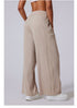Side view of beige wide-leg lounge pants with high waist, paired with white sneakers.