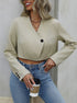 Women's cropped blazer in beige styled with high-waist jeans and layered necklaces