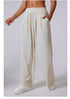 Side view of ivory wide-leg lounge pants with high waist, paired with white sneakers.