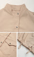 Close-up details of beige jacket showing stand collar, snap buttons, flap pocket and drawstring sleeve