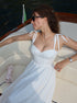 Woman in a white dress on a boat