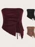 A burgundy ribbed tube top with asymmetric hem featuring adjustable tie detail and mesh trim shown with color options in black and tan