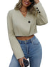 Women's cropped blazer in beige styled with high-waist jeans and layered necklaces