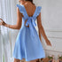 Back detail of light blue dress showing ruffle straps and bow-tied cutout design with decorative trim