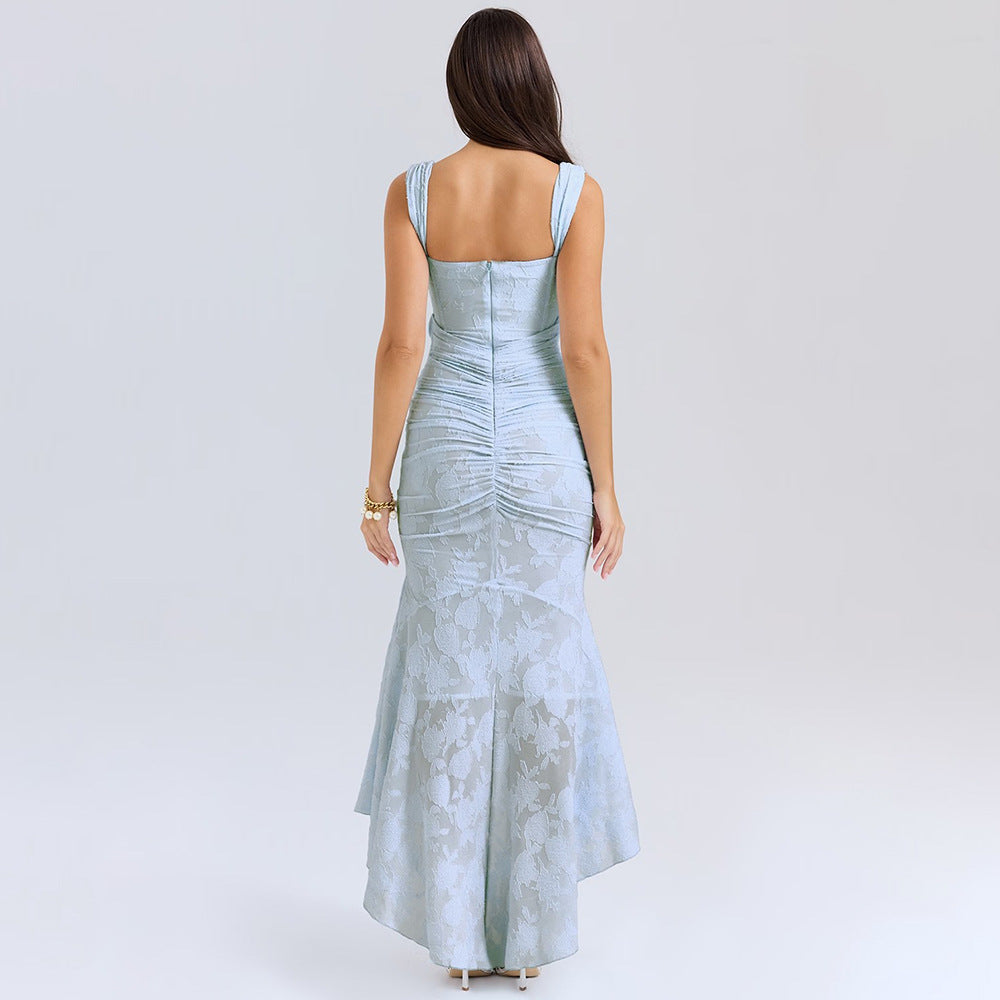 A model is showing the back view of a light blue textured gown with ruched detailing and high-low hemline against a white backdrop