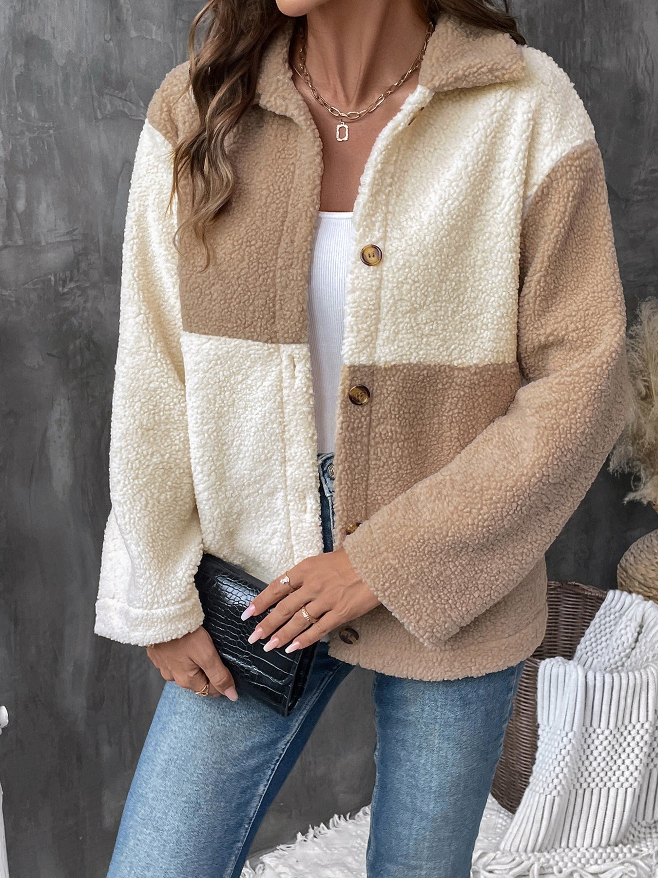 Two-tone beige and cream sherpa jacket with button front over white tank top and jeans