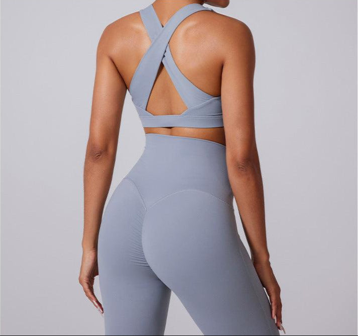 Back view showcasing X-shaped crossed straps design in gray sports bra