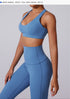 Side view of denim blue workout set on model, including size and measurements information