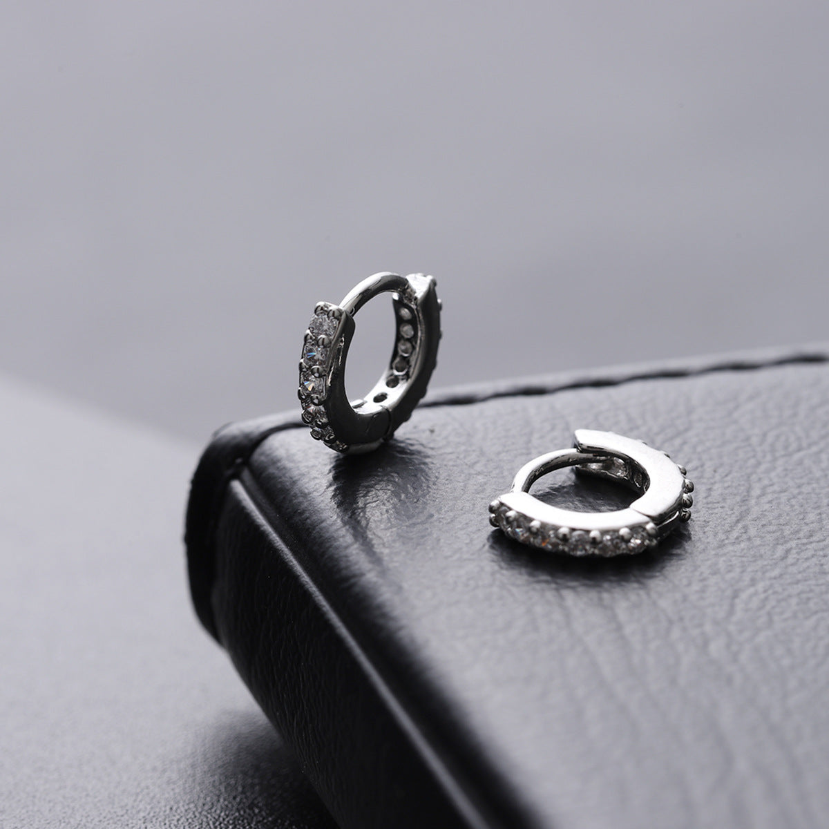 6mm zirconia pavé hoop earrings in silver on textured black display