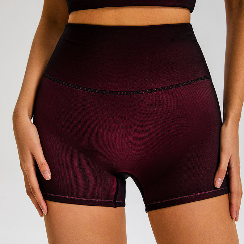 Burgundy compression shorts with high waistband and black contrast stitching against white background
