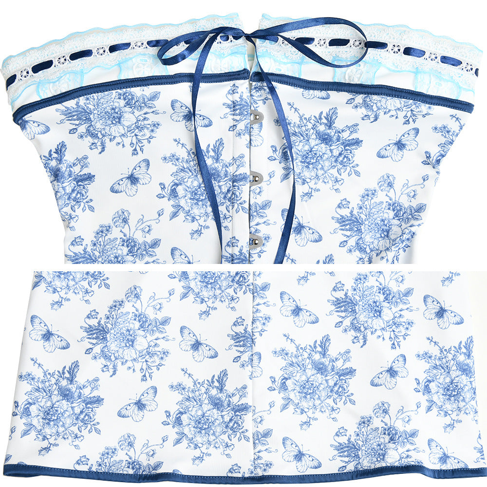 A white strapless mini dress with blue floral and butterfly print, featuring ribbon trim and button front closure, displayed flat against white background