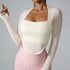 Woman wearing cream textured square-neck top with long sleeves paired with soft pink high-waisted leggings