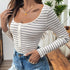 A side view of the woman wearing the bodysuit, showing the scoop neckline and button-up front.
