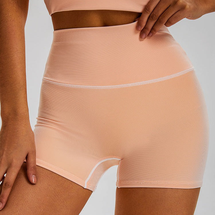 Close-up of nude-colored high-waisted workout shorts with seamless design and contrast stitching detail