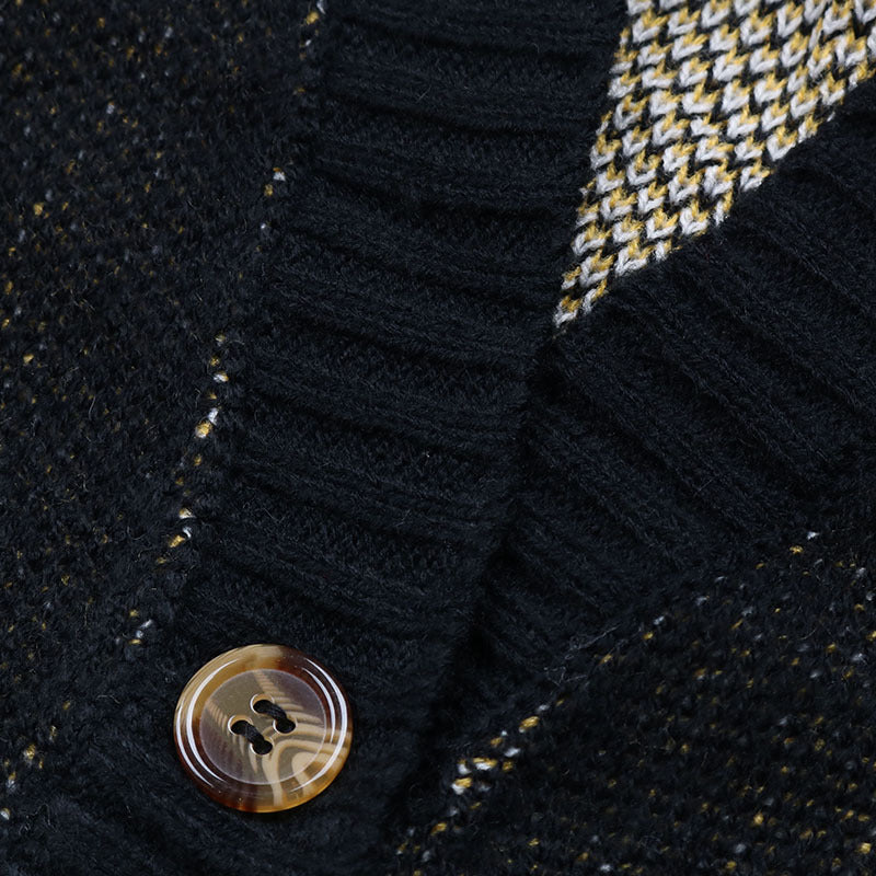 Detailed shot of button and ribbed texture of black daisy knit cardigan