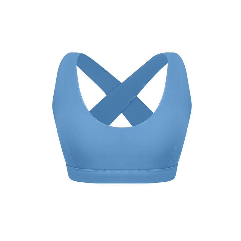 Denim blue sports bra with crossed back straps and scoop neckline
