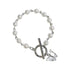 A white pearl bracelet with silver chain links, toggle clasp and butterfly charm photographed against white background